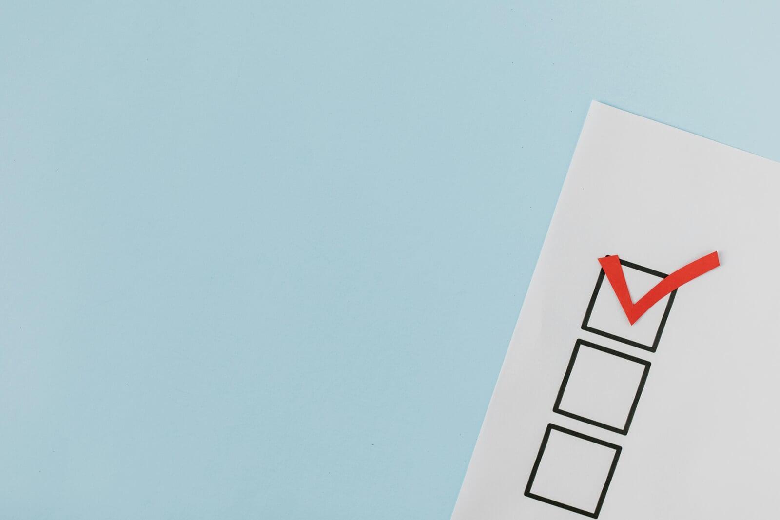 An image of a checkbox with a red tick inside.
